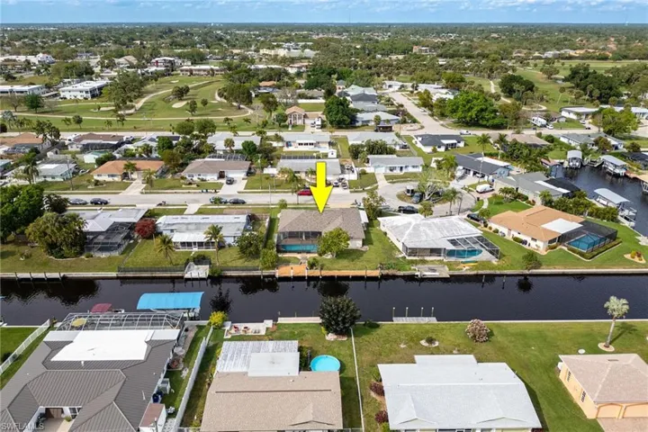 Aerial overview of property's location featuring nearby suburban area and a nearby body of water