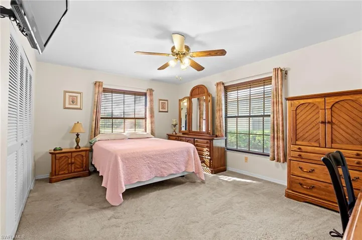 Master Bedroom with light carpet, multiple windows, a closet, and ceiling fan