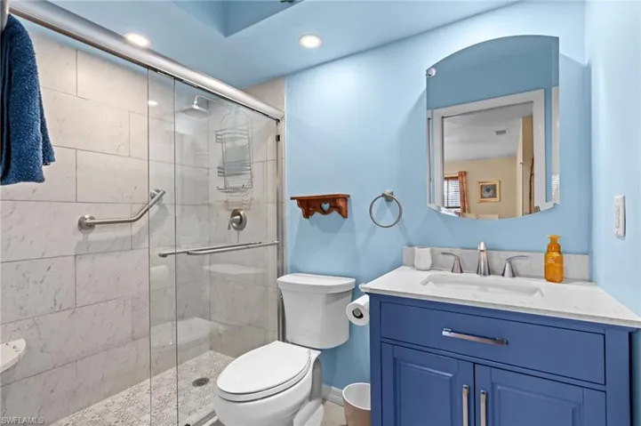 Master Bathroom featuring toilet, vanity, and a shower with shower door