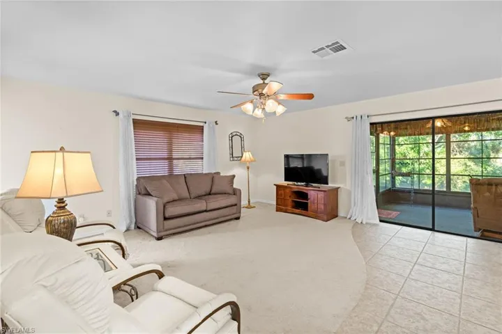 Living room featuring ceiling fan and light tile patterned flooring