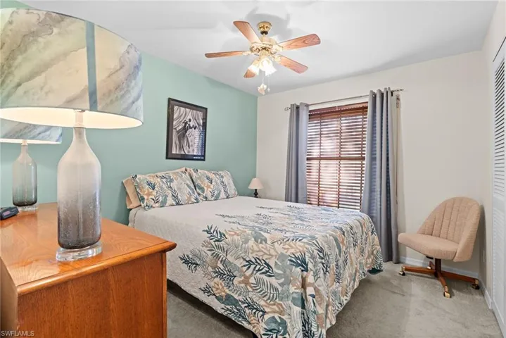 Guest Carpeted bedroom featuring ceiling fan and a closet