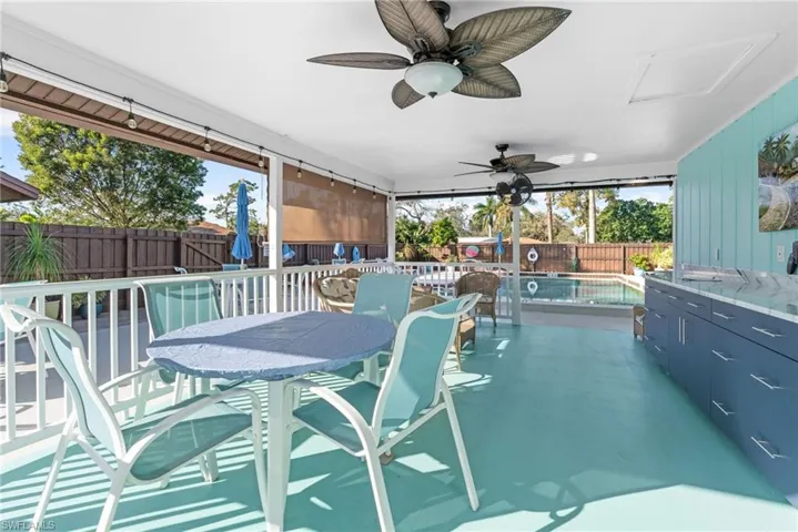 View of swimming pool with ceiling fan