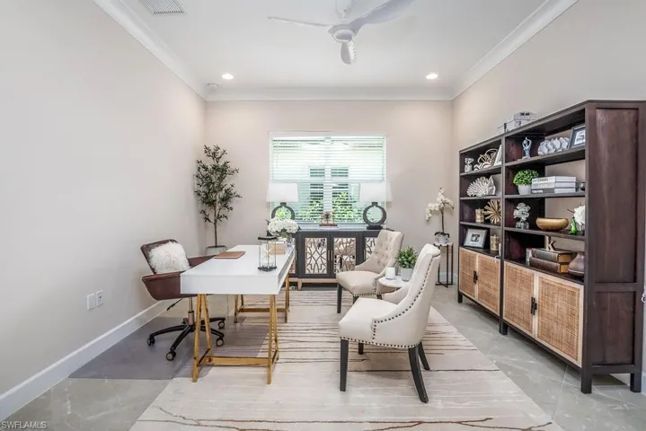 Tiled office space featuring ceiling fan and crown molding