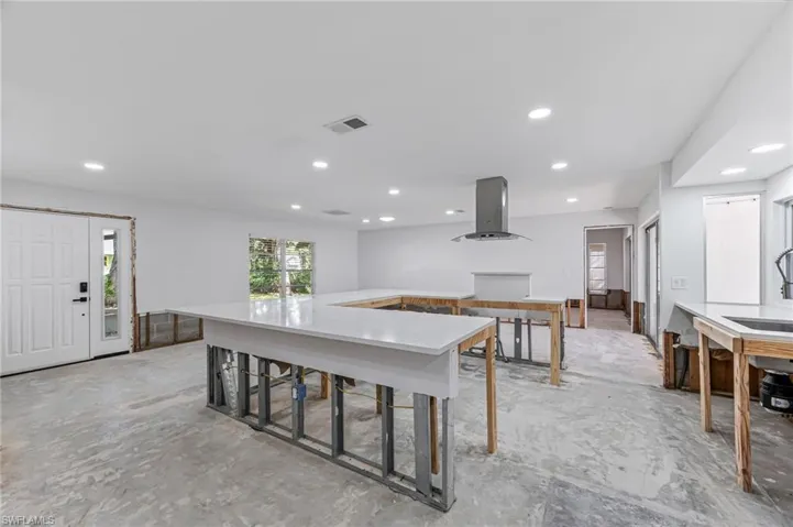 Kitchen with island range hood and sink