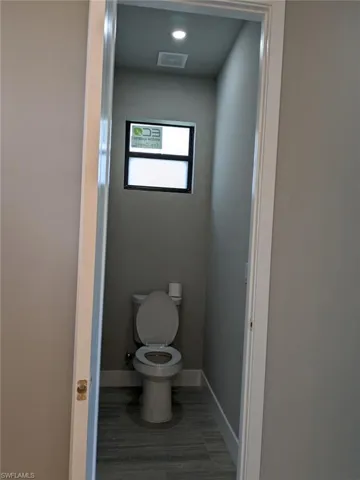 Bathroom featuring toilet and baseboards