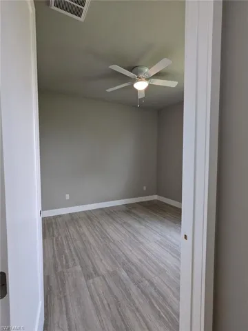 Unfurnished room with light wood-type flooring and a ceiling fan