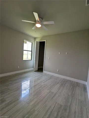 Spare room featuring ceiling fan and light wood-style floors