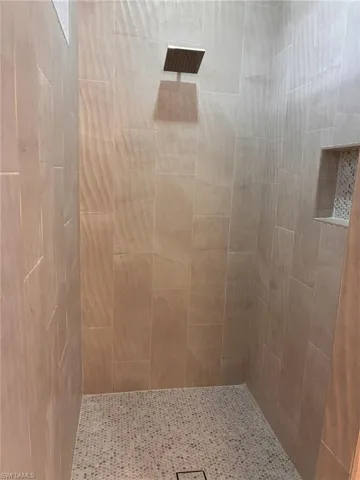 Full bathroom with tiled shower