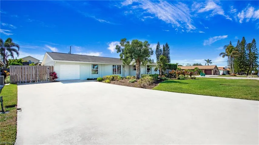 Single story home with a garage, driveway, and stucco siding