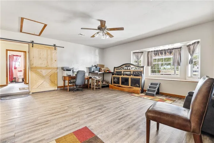 Beautiful bay window and barn door leads to main hallway
