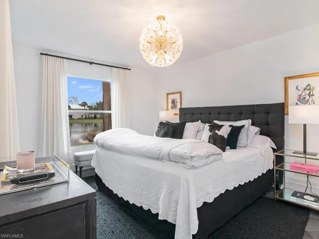 Bedroom with an inviting chandelier