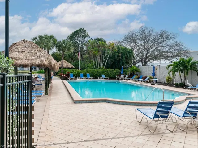 Community pool with a patio, fence, and a gazebo