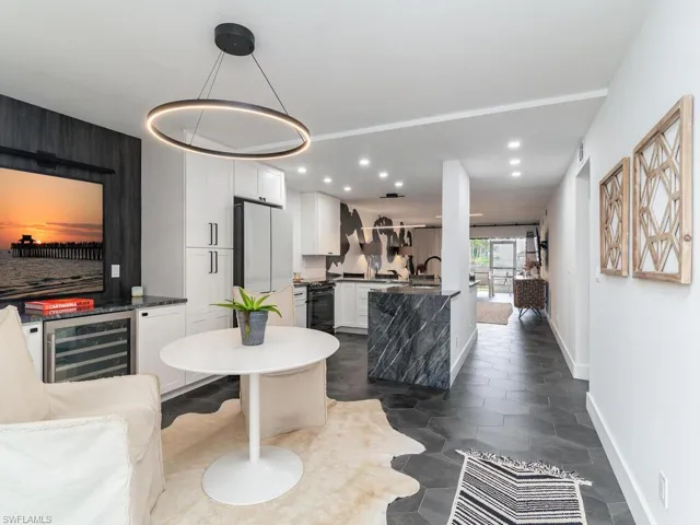 Dining room with baseboards, beverage cooler, and recessed lighting