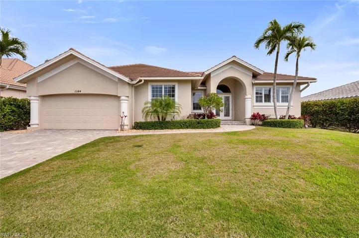 Single story home featuring a garage and a front yard