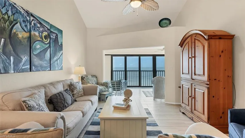 Living area featuring vaulted ceiling and ceiling fan