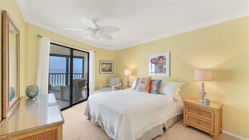 Bedroom featuring ornamental molding, access to outside, carpet flooring, and ceiling fan