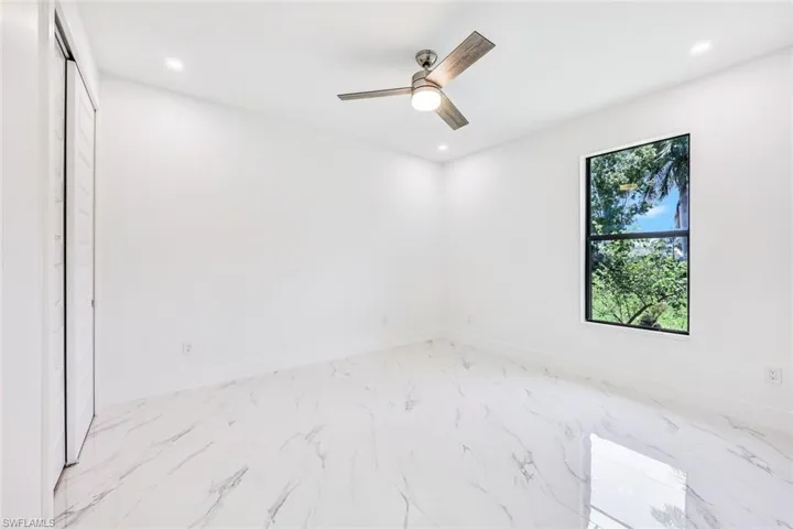 Tiled empty room with ceiling fan