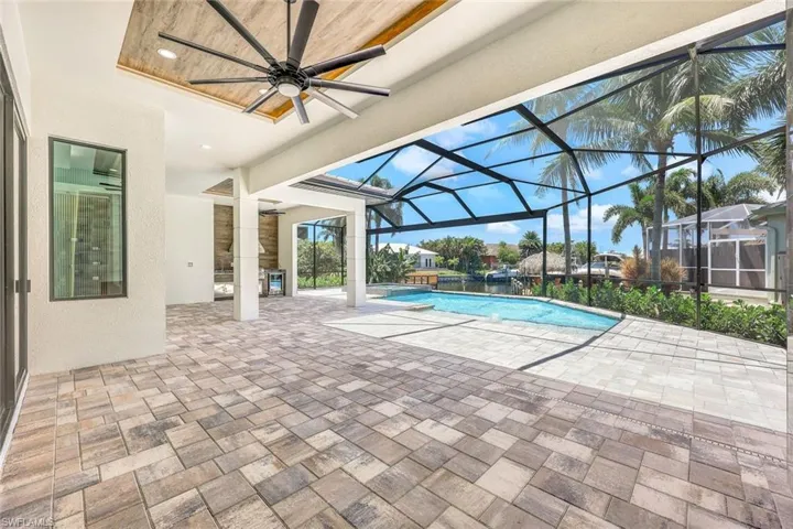View of pool featuring ceiling fan, a patio, and a lanai
