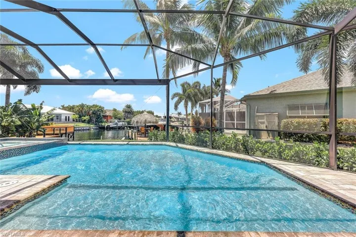 View of swimming pool featuring a lanai