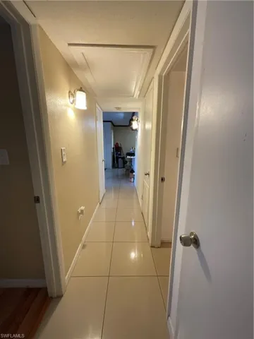 Hall featuring light tile patterned floors