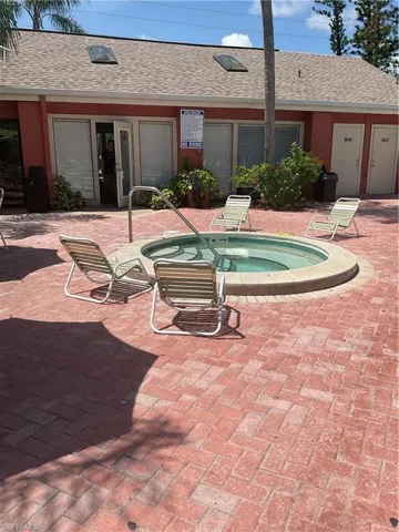 View of swimming pool with a community hot tub and a patio area