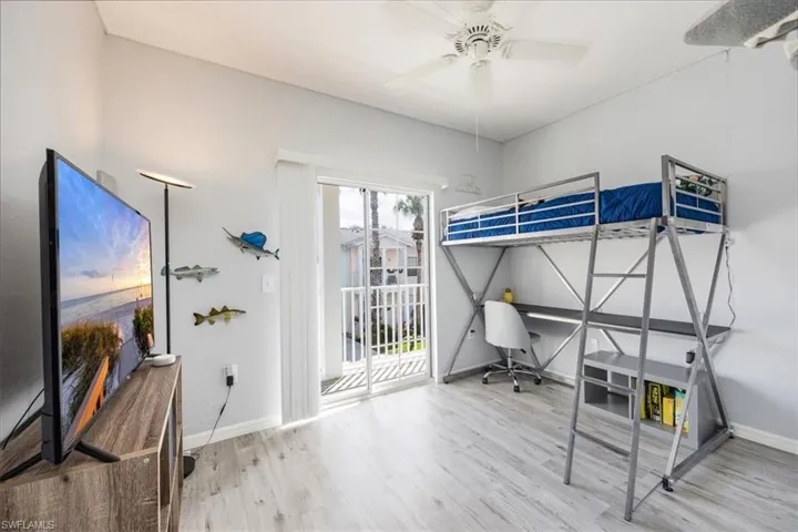 Bedroom featuring ceiling fan, hardwood / wood-style flooring, and access to exterior
