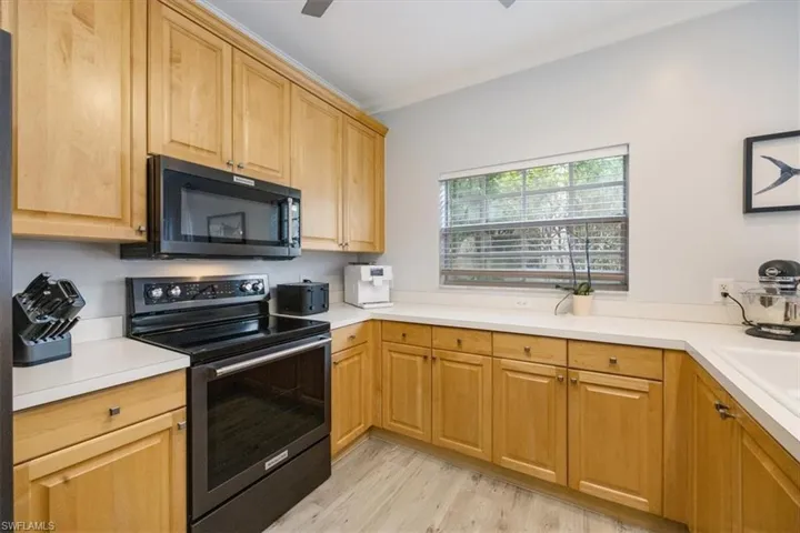 Kitchen with light hardwood / wood-style flooring and stainless steel electric range oven