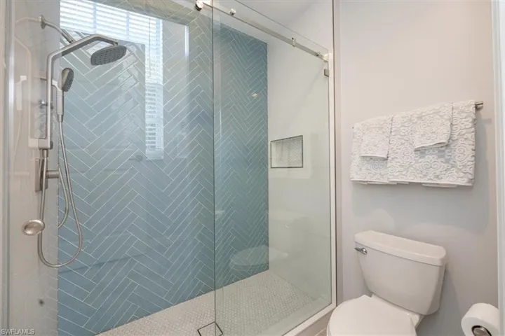Bathroom with toilet and an enclosed shower