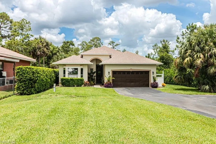 View of front of home featuring asphalt driveway, stucco siding, an attached garage, and a shingled roof