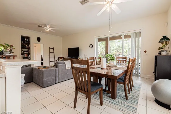 Dining room with a ceiling fan and light tile patterned floors