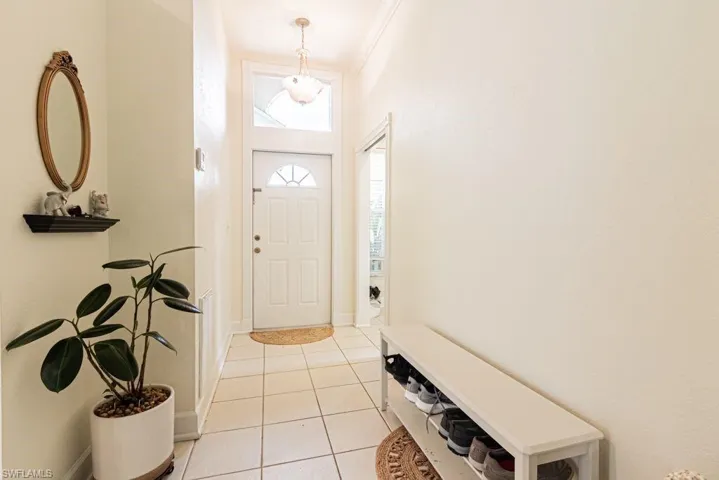 Entryway featuring light tile patterned floors and baseboards