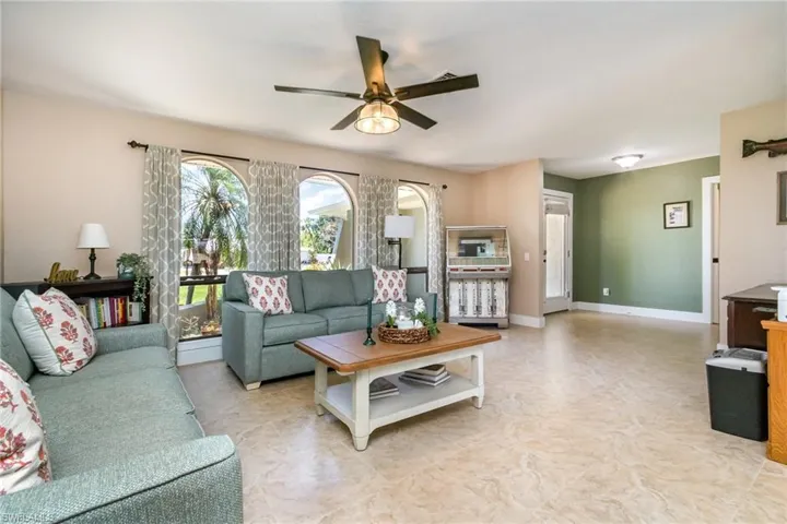 Living area featuring baseboards and a ceiling fan