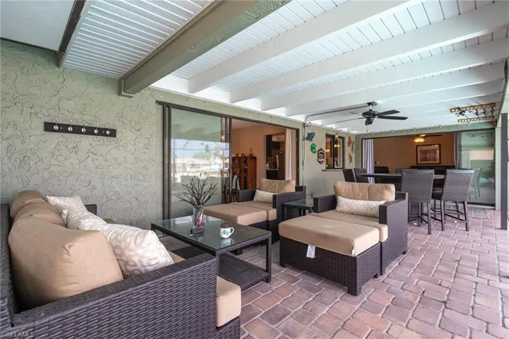 View of patio with outdoor lounge area and ceiling fan