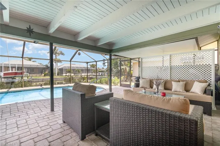 View of patio / terrace featuring an outdoor pool, a residential view, an outdoor hangout area, and a lanai
