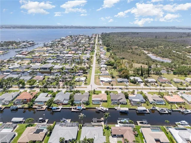 Birds eye view of property with a water view and a residential view