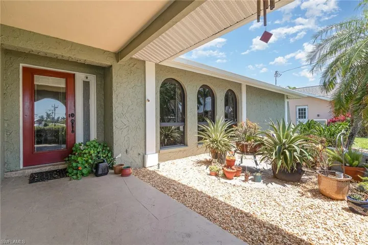 View of exterior entry with stucco siding