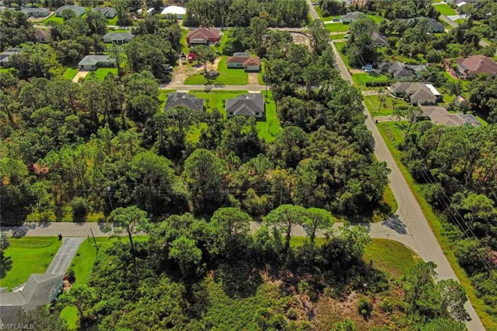 Aerial perspective of suburban area with a tree filled landscape