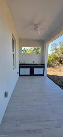 View of patio featuring ceiling fan
