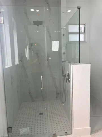 Bathroom with a marble finish shower