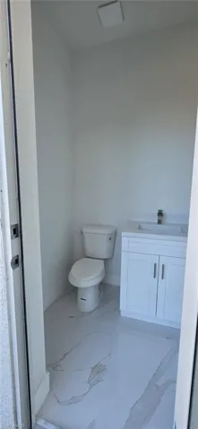 Bathroom with vanity and light marble finish floors