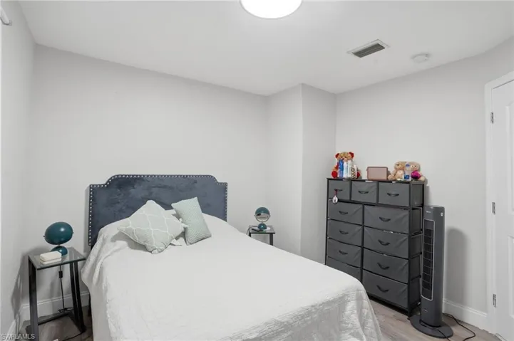 Bedroom with baseboards and light wood-style flooring