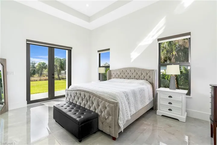 Bedroom with a towering ceiling and french doors