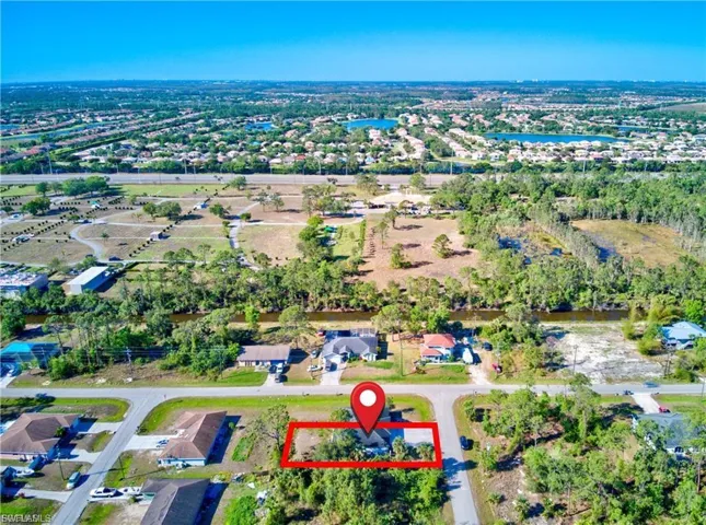Aerial view of residential area featuring property boundaries highlighted