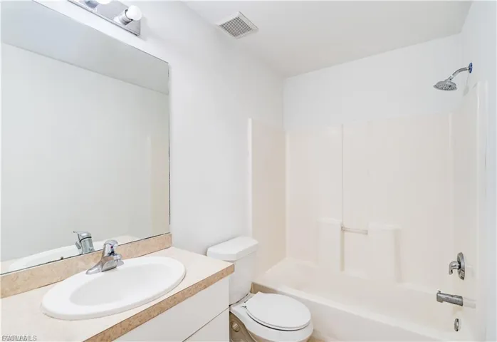 Bathroom with vanity and shower / bathtub combination