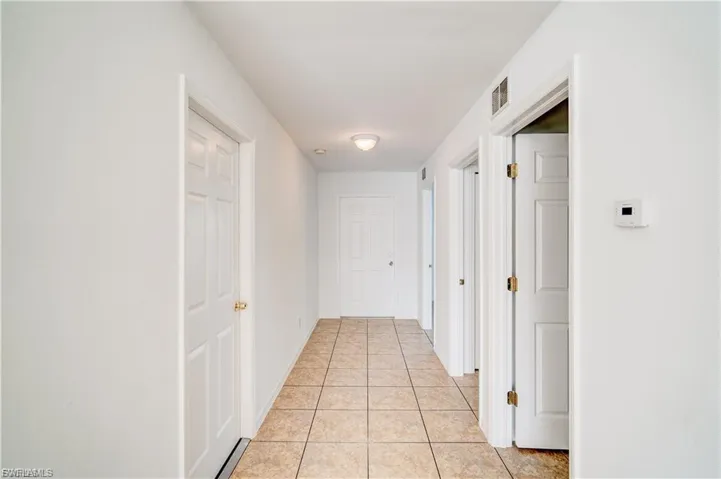 Hall featuring light tile patterned floors