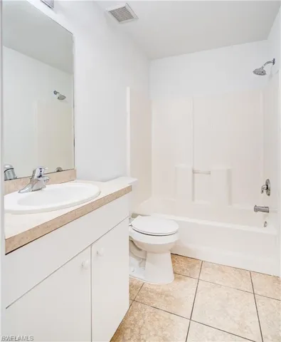 Full bathroom featuring vanity, bathing tub / shower combination, and light tile patterned floors
