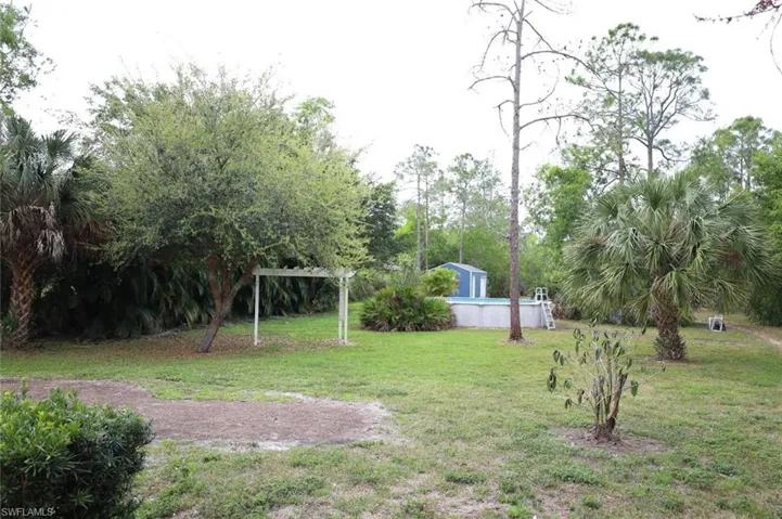 View of green lawn with an outdoor pool