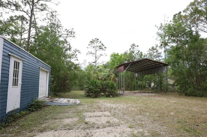 View of yard with a carport