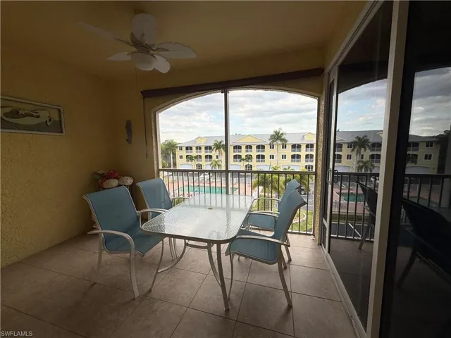 Balcony is screened.  Ceiling fan. Pool and water view