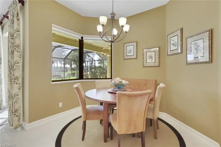 Dining room featuring a chandelier and tile patterned floors